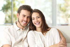 Couple at home looking at camera
